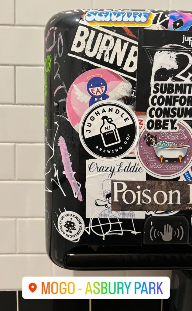 Stickers on a hand dryer at Mogo in Asbury Park: "Do You Know Your Local Robot?"