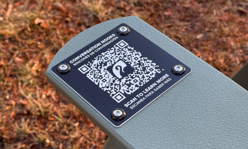 QR code on a bench for accessing information about Conversation Nooks at Roger Williams Park.