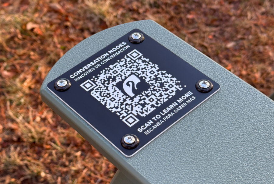 QR code on a bench for accessing information about Conversation Nooks at Roger Williams Park.