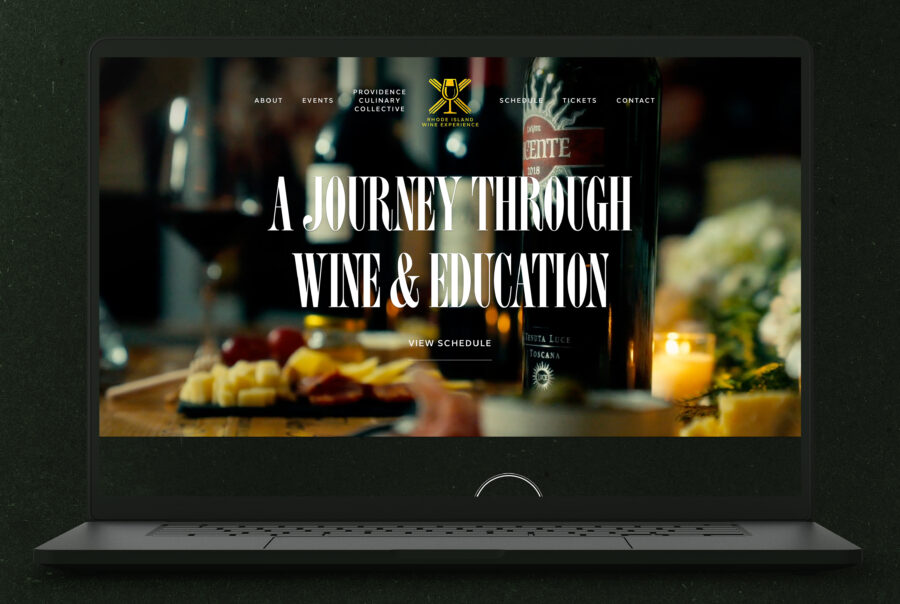 Website displays a wine and education theme with a bottle, glasses, and a cheese platter.
