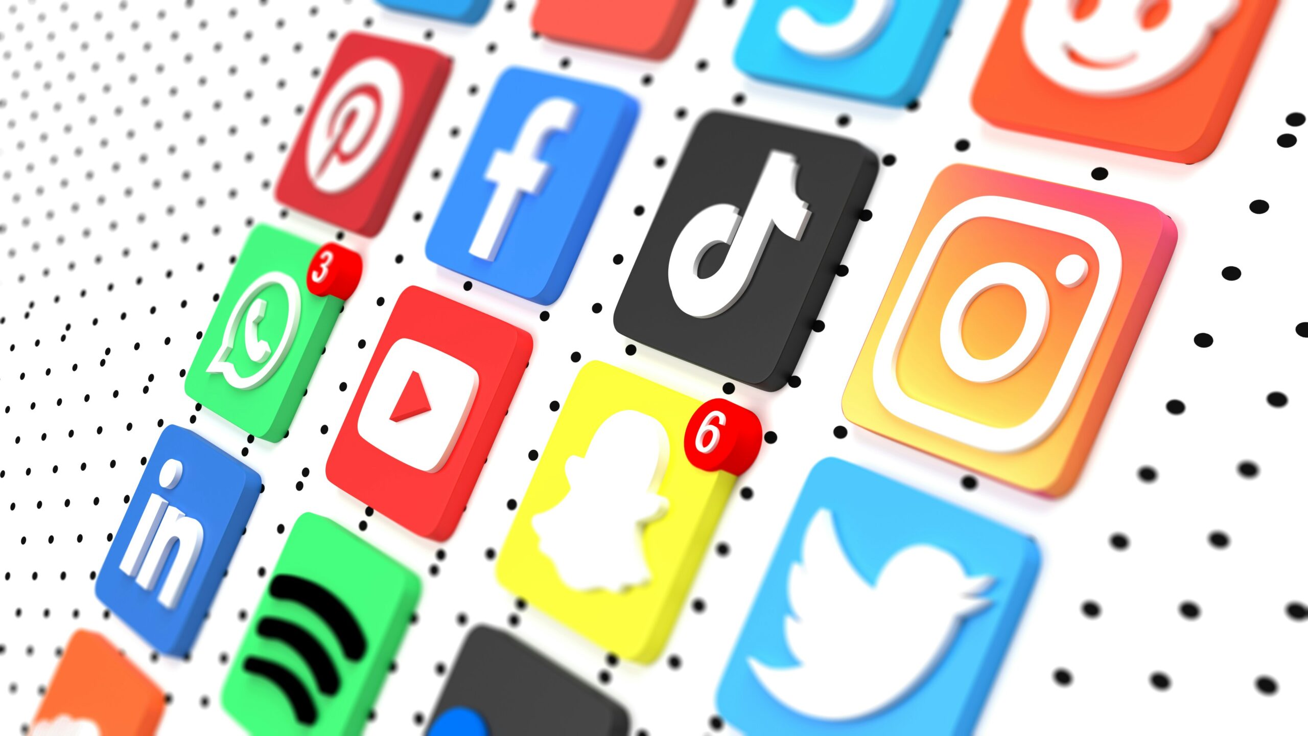 Colorful social media app icons arranged on a dotted background, with notification badges visible.
