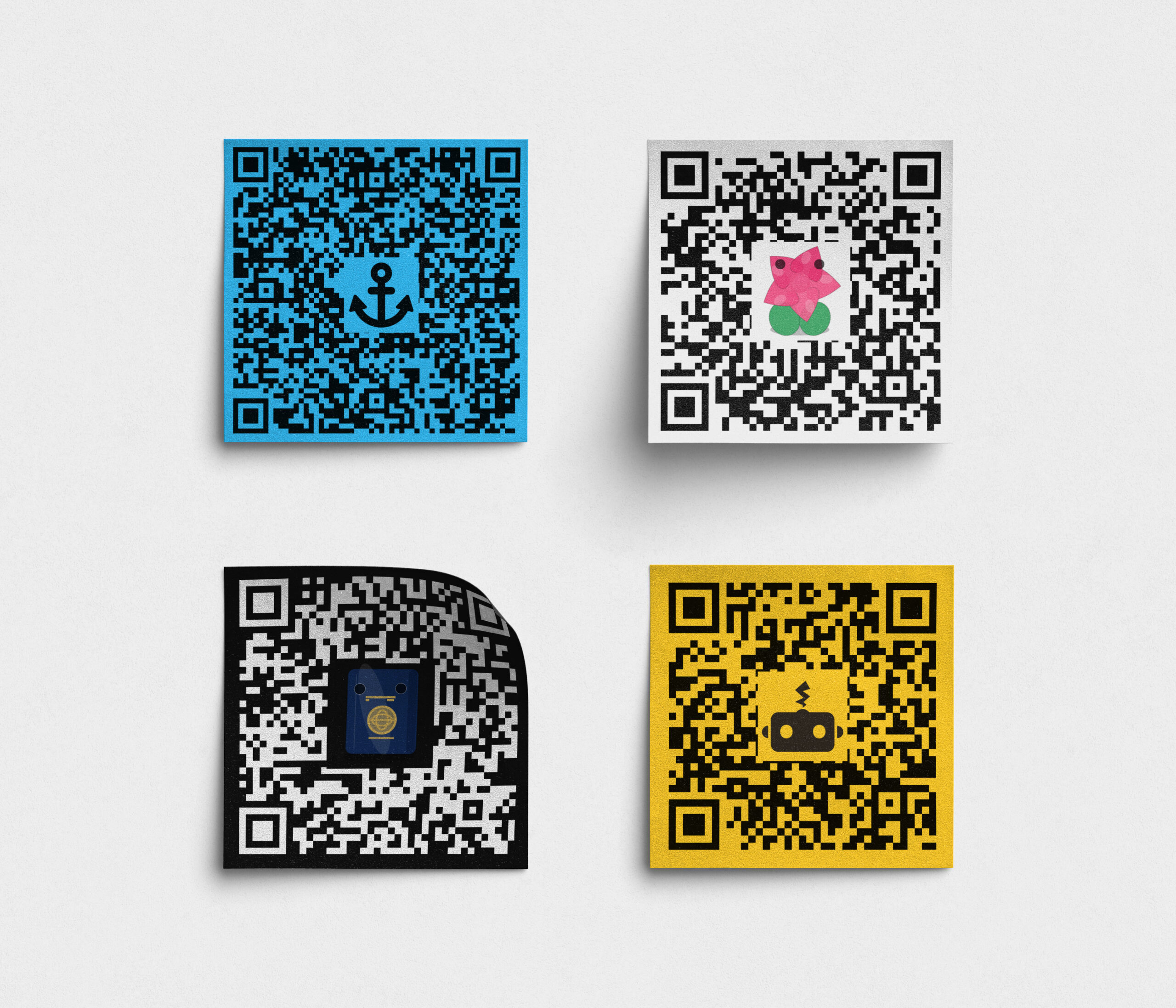 Four QR codes in different colors, featuring various designs and patterns.